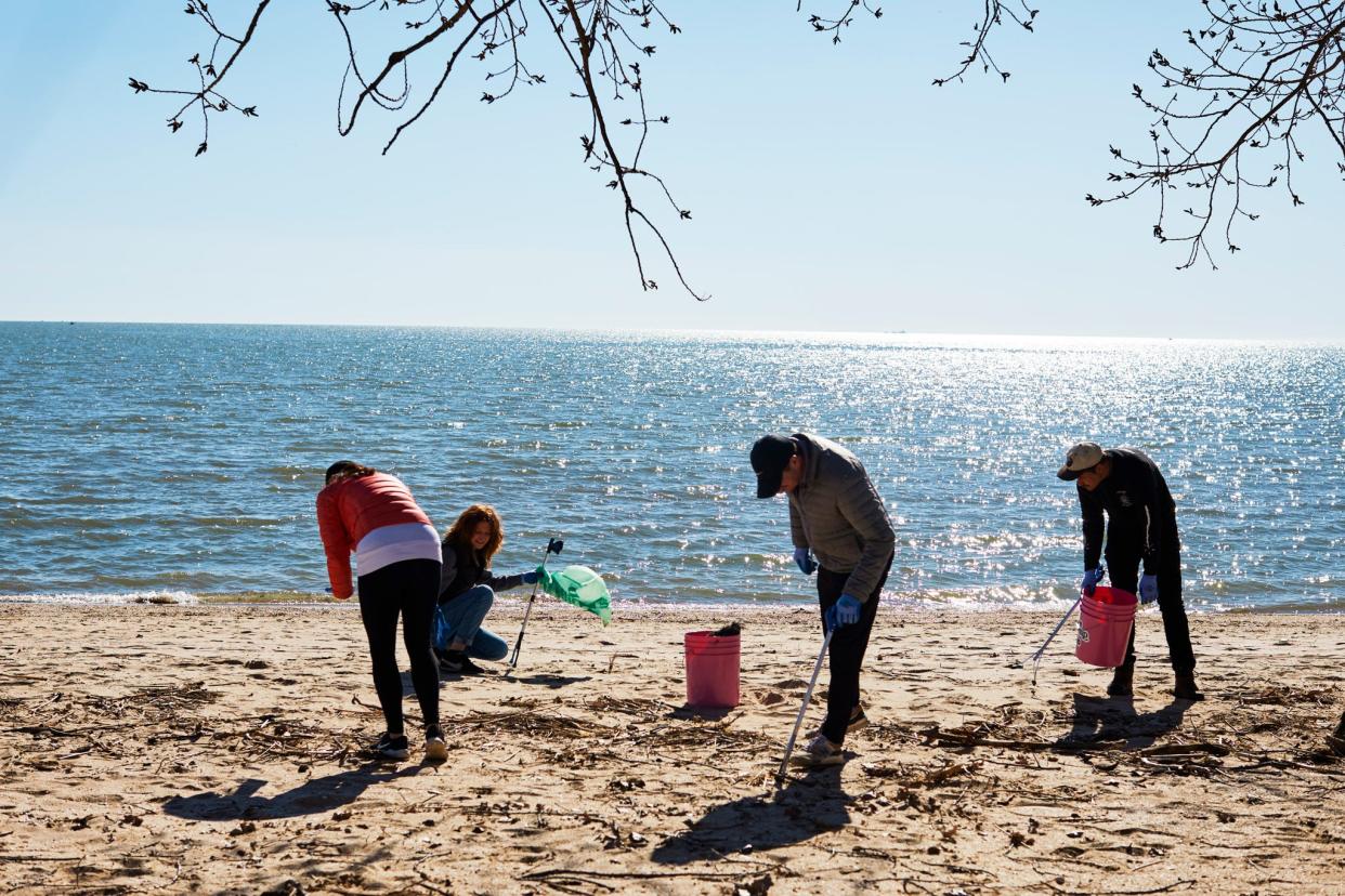 Volunteers of The CleanUp Club take time to clean up trash and plastic debris from Lake Erie's shoreline.