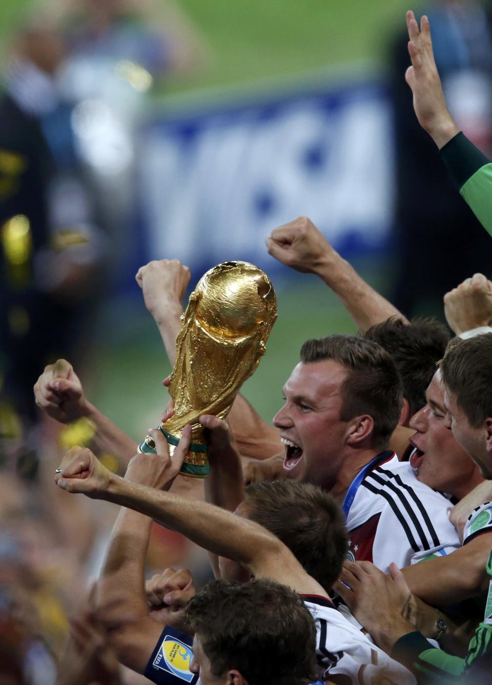 Germany's players lift the World Cup trophy after they beat Argentina in the 2014 World Cup final at the Maracana stadium in Rio de Janeiro