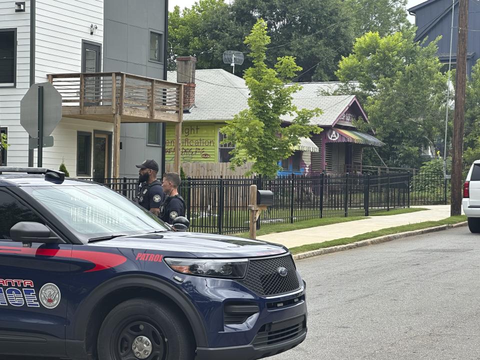 Police block traffic in the block of a house in the Edgewood neighborhood where three key organizers who have been aiding protesters against the city's proposed public safety training center were arrested on Wednesday, May 31, 2023, Atlanta, Georgia The three are officers of the group that runs the Atlanta Solidarity Fund, which has bailed out people arrested during protests against the project, which opponents derisively call "Cop City." (AP Photo/Kate Brumback)