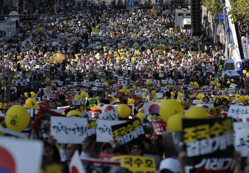 Pro-government supporters shout slogans before a rally supporting Justice Minister, Cho Kuk in front of Seoul Central District Prosecutors' Office in Seoul, South Korea, Saturday, Oct. 12, 2019. Tens of thousands of government supporters have gathered in South Korea’s capital for the fourth-straight weekend to show their support for President Moon Jae-in’s controversial justice minister who’s enmeshed in explosive political scandal that rocked and polarized the nation. The letters read "Reform the Prosecution" and "Protect Cho Kuk". (AP Photo/Lee Jin-man)