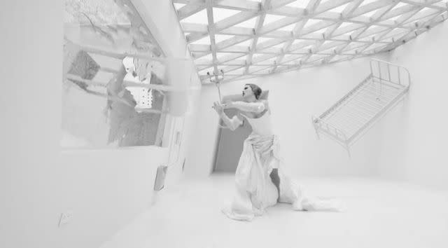 <p>Taylor Swift</p> Taylor Swift wearing a white gown in 'Fortnight' video