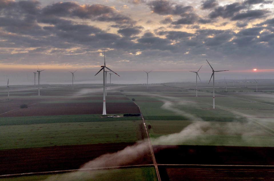 FILE - Wind turbines operate at an energy plant near Stetten, north of Kaiserslautern, Germany, as the sun rises on, March 19, 2024. According to a new report published Tuesday, April 16, 2024, last year, marked the best year for new wind projects. (AP Photo/Michael Probst, File)