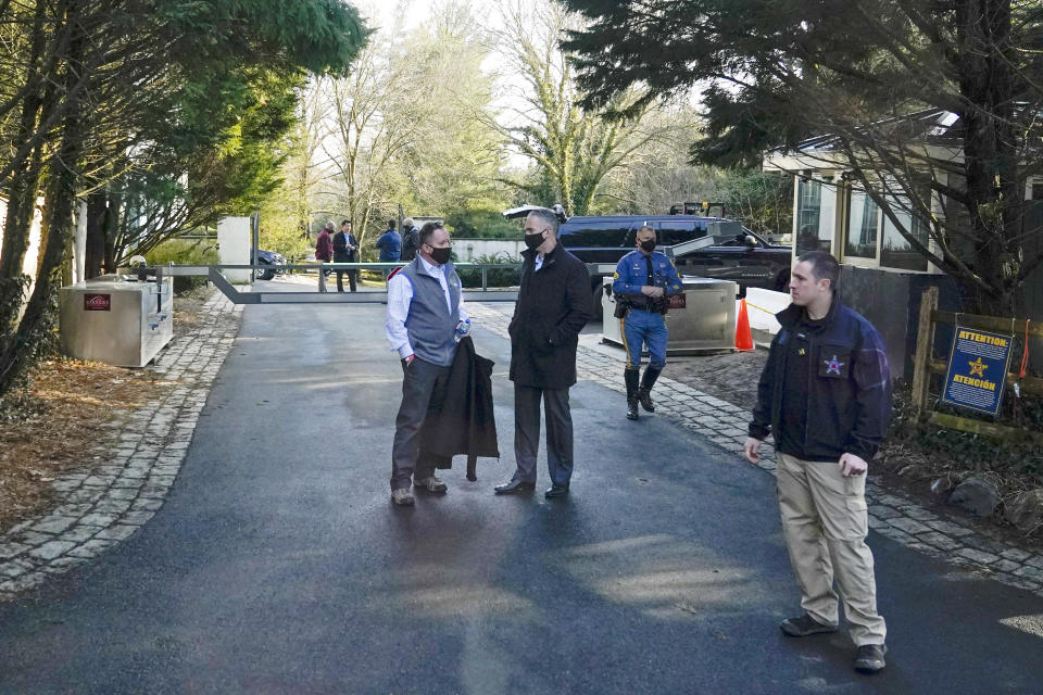 FILE - Security personnel stand at the entrance to President Joe Biden and first lady Jill Biden's home in Wilmington, Del., on Feb. 21, 2021. Biden acknowledged on Thursday that a document with classified markings from his time as vice president was found in his “personal library” at his home in Wilmington, Delaware, along with other documents found in his garage, days after it was disclosed that sensitive documents were also found at the office of his former institute in Washington. (AP Photo/Patrick Semansky, File)