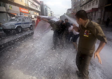 Turkish police use a water cannon to disperse demonstrators during a funeral ceremony for Gunay Ozarslan, a member of the far-left People's Front who, according to local media reports, was killed by Turkish police during a security operation on Friday, in Istanbul, Turkey July 25, 2015. REUTERS/Huseyin Aldemir