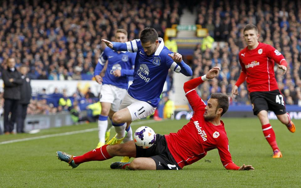 Everton's Kevin Mirallas , left, and Cardiff City's Juan Cala battle for the ball during their English Premier League soccer match at Goodison Park, Liverpool, England, Saturday, March 15, 2014. (AP Photo/Peter Byrne, PA Wire) UNITED KINGDOM OUT - NO SALES - NO ARCHIVES