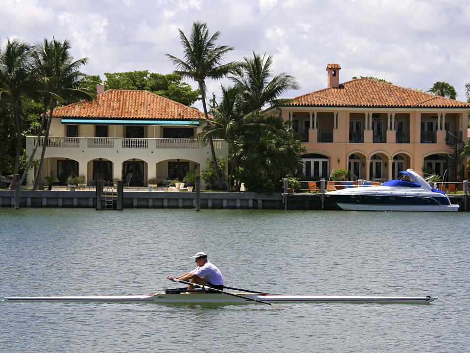 A man rows past Indian Creek homes.