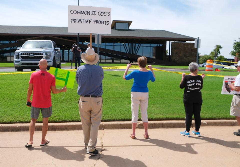 Members of Pike Off, a group opposed to the ACCESS Oklahoma turnpike expansion, hold a protest Tuesday, Aug. 30, 2022, outside a fundraiser for Gov. Kevin Stitt at the Association of Oklahoma General Contractors.