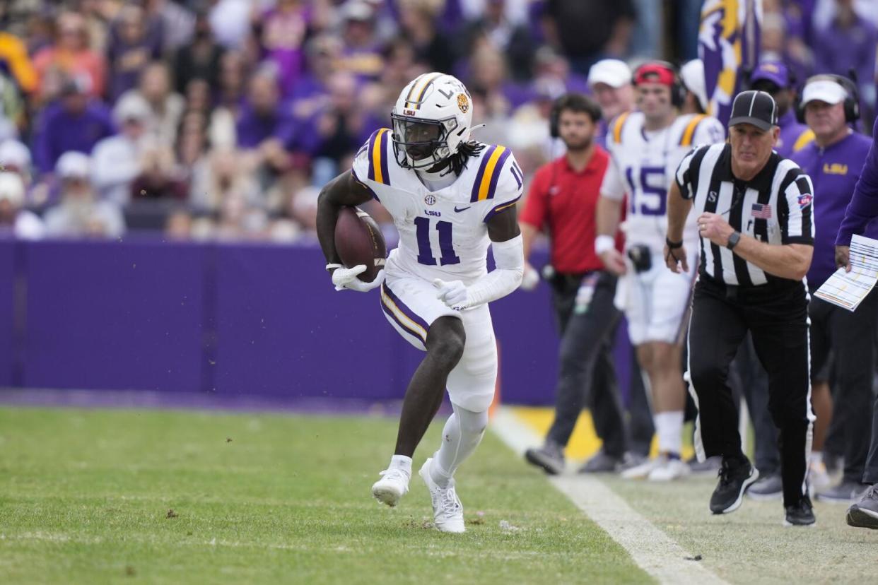 Louisiana State receiver Brian Thomas Jr. carries the football against Texas A&M.