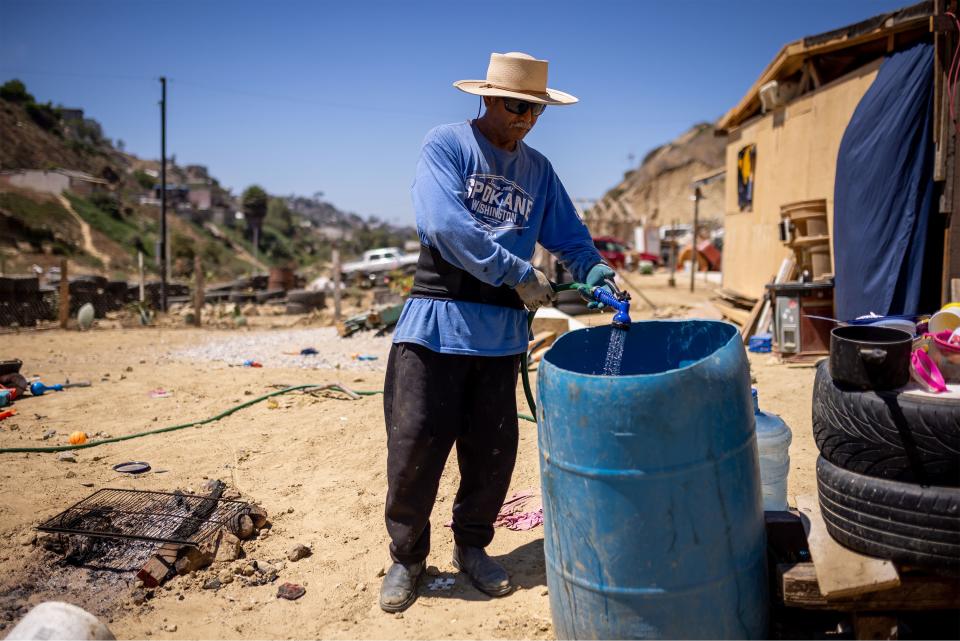 Jose Lopez shows the slight water flow he receives at his home in the Los Laureles neighborhood of Tijuana, Baja California, Mexico. | Spenser Heaps, Deseret News