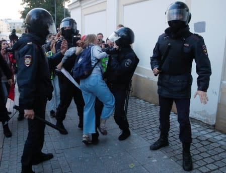 Law enforcement officers detain Muscovite Daria Sosnovskaya after a rally to demand authorities allow opposition candidates to run in a local election in Moscow