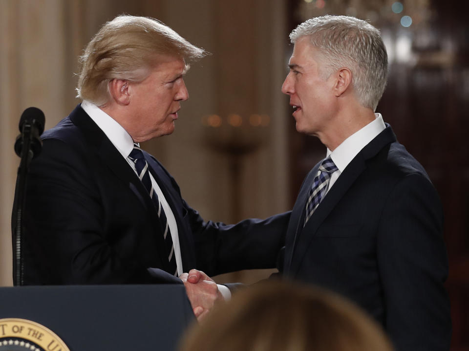 FILE - In this Jan. 31, 2017, file photo, President Donald Trump shakes hands with 10th U.S. Circuit Court of Appeals Judge Neil Gorsuch, his choice for Supreme Court Justice in the East Room of the White House in Washington. Gorsuch is roundly described by colleagues and friends as a silver-haired combination of wicked smarts, down-to-earth modesty, disarming warmth and careful deliberation. His critics largely agree with that view of the self-described “workaday judge” in polyester robes. Even so, they’re not sure it’s enough to warrant giving him a spot on the court. (AP Photo/Carolyn Kaster, file)