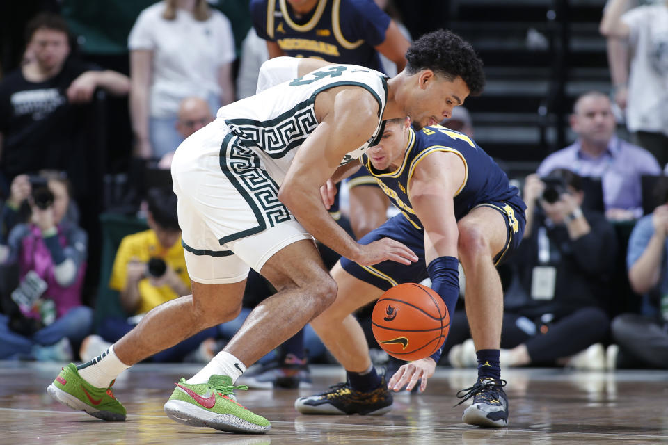 Michigan's Joey Baker, right, tries for a steal against Michigan State's Malik Hall during the first half of an NCAA college basketball game, Saturday, Jan. 7, 2023, in East Lansing, Mich. (AP Photo/Al Goldis)