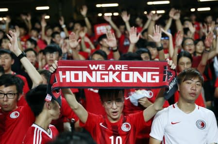 Soccer fans demonstrate inside Hong Kong Stadium