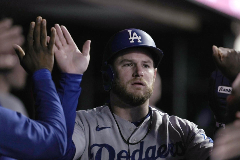 Los Angeles Dodgers' Max Muncy is congratulated in the dugout after scoring against the San Francisco Giants during the second inning of a baseball game Friday, Sept. 16, 2022, in San Francisco. (AP Photo/Tony Avelar)