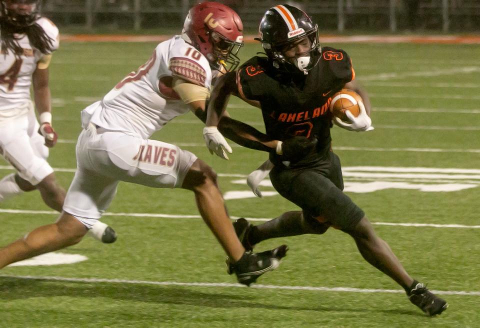 Lakeland High School running back D' Marius Rucker (3) rushes the ball against Lake Gibson High School during the first half of their Class 4S, Region 2, District 7 semifinal playoff game at Bryant Stadium Friday night. November 11, 2022