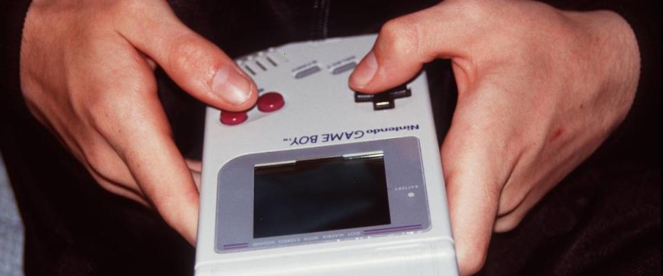 Closeup of hands holding a GameBoy