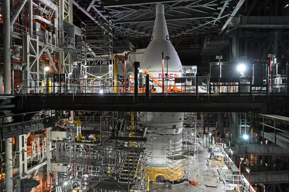 FILE - A section of the Artemis rocket with the Orion space capsule is seen inside the Vehicle Assembly Building at the Kennedy Space Center, Friday, Nov. 5, 2021, in Cape Canaveral, Fla. The Orion capsule is named after the constellation, among the night sky’s brightest. At 11 feet (3 meters) tall, it’s roomier than Apollo's capsule, seating four astronauts instead of three. (AP Photo/John Raoux, File)