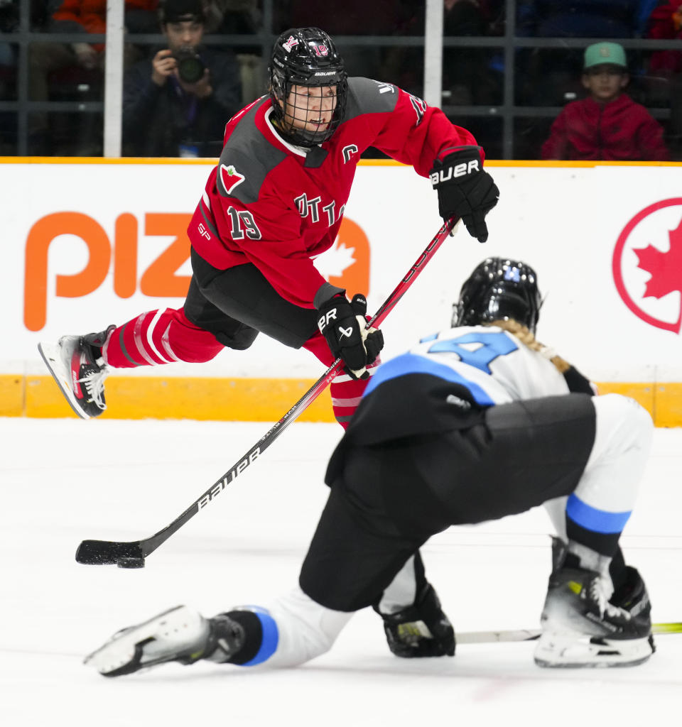 Ottawa's Brianne Jenner (19) takes a shot on net as Toronto's Renata Fast (14) attempts to block the shot during the second period of a PWHL hockey game Tuesday, Jan. 23, 2024, in Ottawa, Ontario. (Sean Kilpatrick/The Canadian Press via AP)