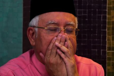 Malaysia’s former Prime Minister Najib Razak prays before he attends the United Malays National Organisation (UMNO) 72th anniversary celebrations in Kuala Lumpur, Malaysia May 11, 2018. REUTERS/Athit Perawongmetha//Files