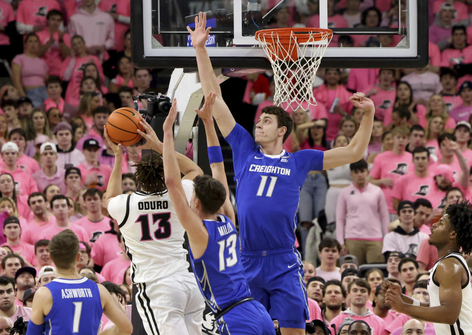 Creighton forward Mason Miller (13) and center Ryan Kalkbrenner (11) defend against Providence forward Josh Oduro (13) during the first half of an NCAA college basketball game Wednesday, Feb. 7, 2024, in Providence, R.I. (AP Photo/Mark Stockwell)