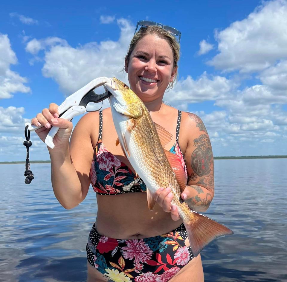 Katrice Austreng holds up dinner she caught while fishing with the “Boatsticks” crew this past week. Redfish and trout are plentiful in the Big Bend region this time of year.