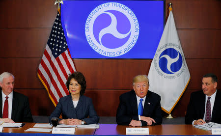 FILE PHOTO: U.S. President Donald Trump (2NDR) participates in a roundtable discussion with Deputy Transportation Secretary Jeff Rosen (L), Transportation Secretary Elaine Chao and Walter Waidelich (R) at the Department of Transportation in Washington, U.S. June 9, 2017. REUTERS/Jonathan Ernst/File Photo