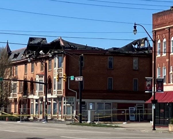 Yellow caution tape surrounds the Avalon Apartments on Sunday, a day after a two-alarm fire severely damaged the building in downtown Newark.