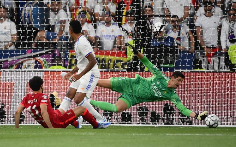 Real Madrid's Belgian goalkeeper Thibaut Courtois (R) makes a save from an attempt by Liverpool's  -  FRANCK FIFE/AFP via Getty Images