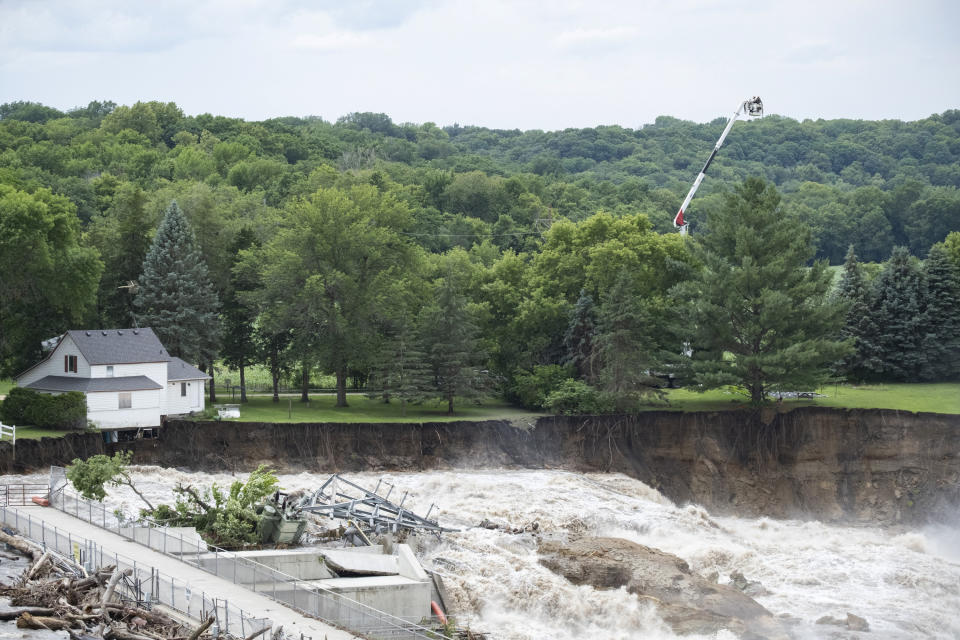 Crews survey the area surrounding the Rapidan Dam from a lift, Monday, June, 24, 2024, in Rapidan, Minn. (Casey Ek/The Free Press via AP)