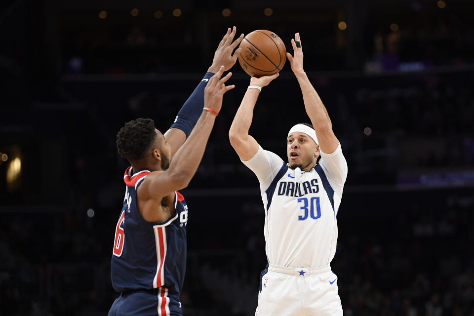 Dallas Mavericks guard Seth Curry (30) shoots as he is defended by Washington Wizards forward Troy Brown Jr. (6) during the first half of an NBA basketball game, Friday, Feb. 7, 2020, in Washington. (AP Photo/Nick Wass)