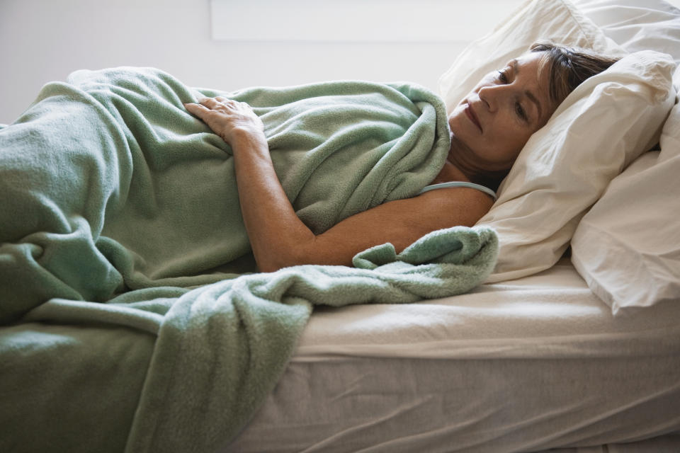 Woman awake in bed. (Getty Images)