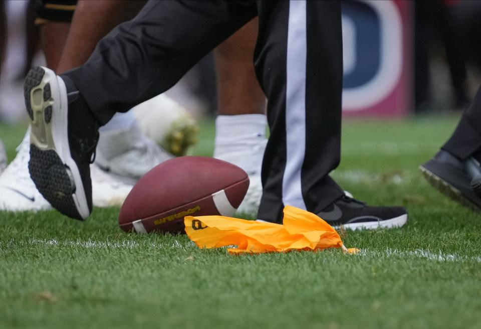 A penalty flag is dropped near the football after Iowa State defensive end Will McDonald was called for a facemask penalty against Baylor at Jack Trice Stadium in Ames on Saturday.