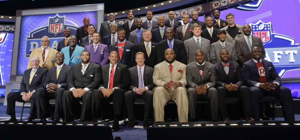 Former NFL players representing all 32 teams in the league gather on stage before the start of the second round of the 2014 NFL Draft, Friday, May 9, 2014, in New York. (AP Photo/Jason Decrow)