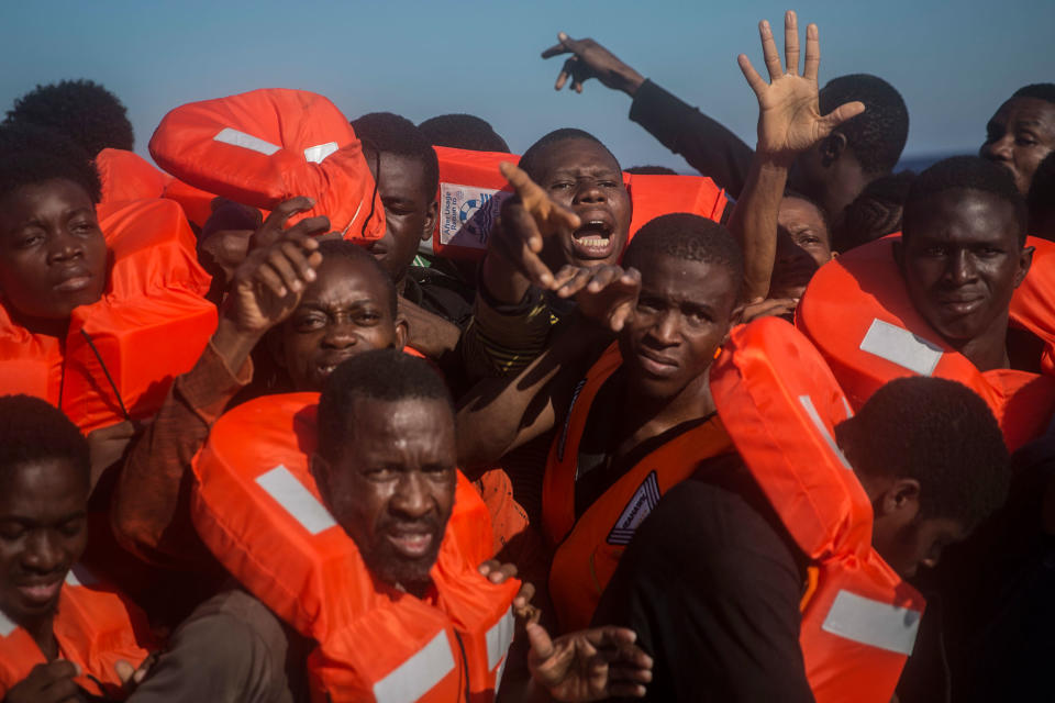 <p>Sub-saharan refugees and migrants, mostly from Nigeria, aboard a partially punctured rubber boat, receive life jackets during a rescue operation on the Mediterranean sea, about 19 miles north of Az Zawiyah, Libya, on Thursday, July 21, 2016. (AP Photo/Santi Palacios) </p>