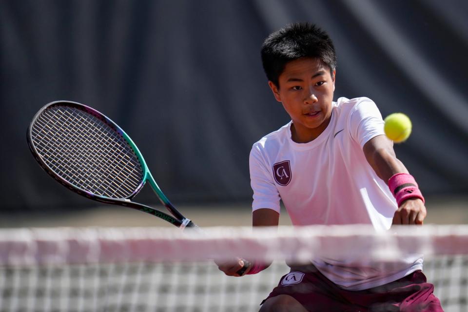 Columbus Academy's Nason Lo hits the ball while playing doubles with brother Rowen Lo during last year's Division II state tournament. Nason is playing singles this postseason, while Rowen is teaming with Lucas Xue in doubles.