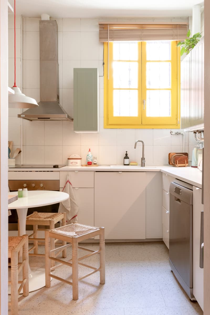 White kitchen with window with yellow trim