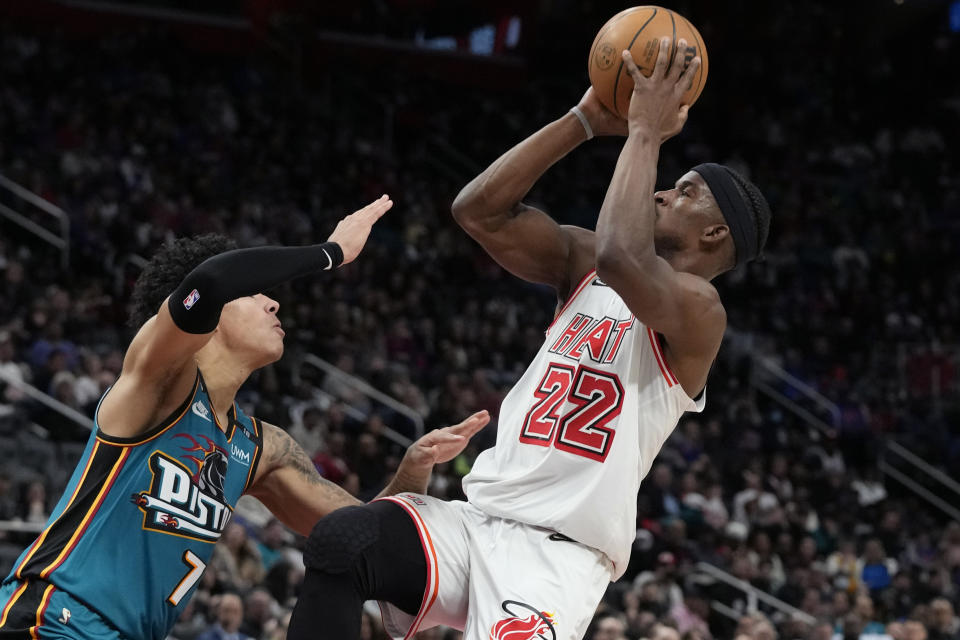 Miami Heat forward Jimmy Butler (22) shoots over the defense of Detroit Pistons guard Killian Hayes (7) during the second half of an NBA basketball game, Tuesday, April 4, 2023, in Detroit. (AP Photo/Carlos Osorio)