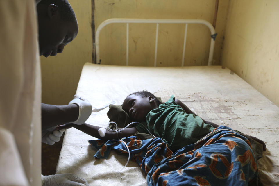 FILE - In this Monday, Sept. 6, 2010 file photo, a doctor treats a child suffering from cholera, at a village health clinic in Ganjuwa in Nigeria's rural Bauchi State. Nigeria is seeing one of its worst cholera outbreaks in years, with more than 2,300 people dying from suspected cases as the West African nation struggles to deal with multiple disease outbreaks. The 2021 outbreak which is associated with a higher case fatality rate than the previous four years is also worsened by what many consider to be a bigger priority for state governments: the COVID-19 pandemic. (AP Photo/Sunday Alamba, File)