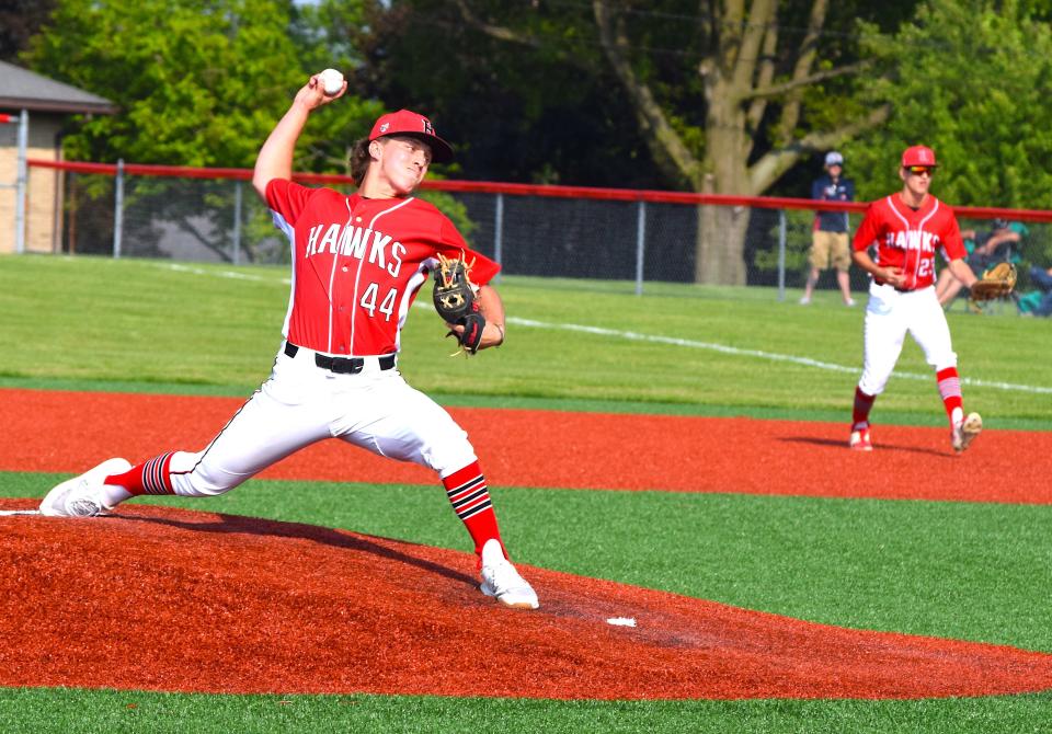 Hiland pitcher Isaak Yoder delivers against Conotton Valley as first baseman Caden Coblentz prepares for action behind him. Yoder allowed one run on one hit over four innings as the Hawks rolled to the East District title 11-1.