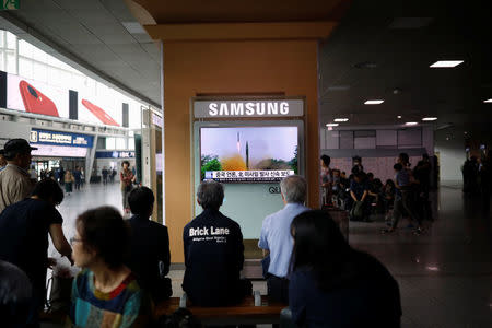 People watch a television broadcasting a news report on North Korea firing what appeared to be a short-range ballistic missile, at a railway station in Seoul, South Korea, May 29, 2017. REUTERS/Kim Hong-Ji