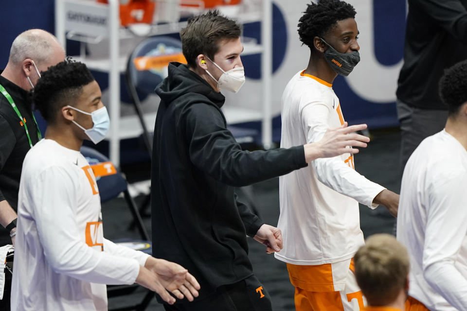 Injured Tennessee forward John Fulkerson, center, cheers on his teammates in the first half of an NCAA college basketball game against Alabama in the Southeastern Conference Tournament Saturday, March 13, 2021, in Nashville, Tenn. (AP Photo/Mark Humphrey)