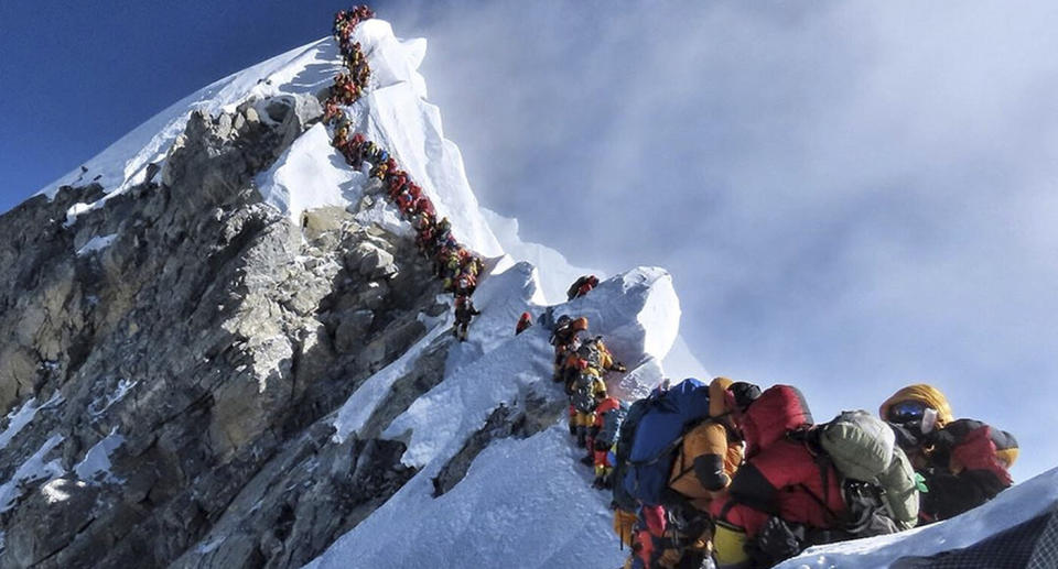 In this photo made on May 22, 2019, a long queue of mountain climbers line a path on Mount Everest. Source: AP