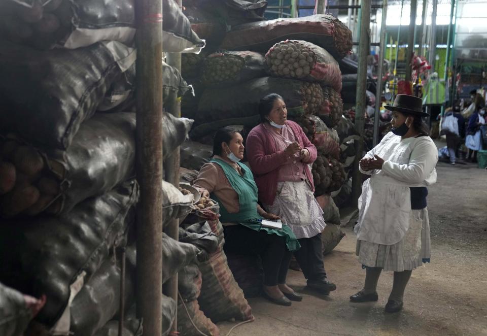 Indigenous women speak to each other in the Quechua Indigenous language at the Nery Garcia Market in Huamanga, Peru, Thursday, Sept. 2, 2021. Quechua is spoken by an estimated 10 million people in the region, largely in Peru, Ecuador and Bolivia. (AP Photo/Martin Mejia)