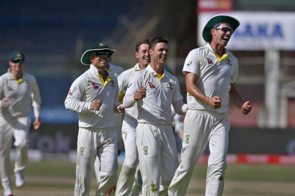 Australia's Mitchell Swepson, second right, and teammates celebrate after the dismissal of Pakistan Babar Azam on the third day of the second test match between Pakistan and Australia at the National Stadium in Karachi, Pakistan, Monday, March 14, 2022. (AP Photo/Anjum Naveed)