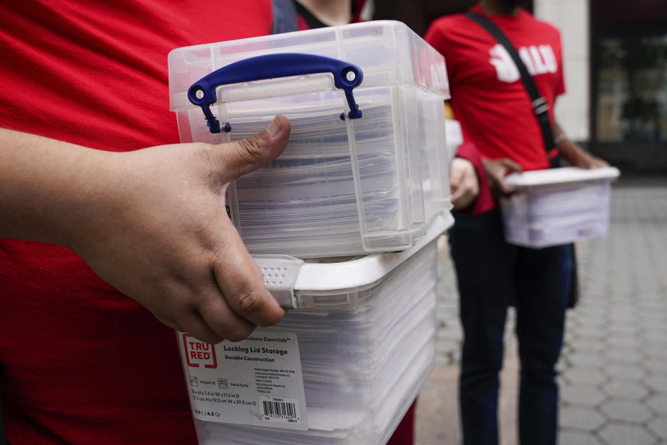 Organizers deliver "Authorization of Representation" forms to the National Labor Relations Board in New York, Monday, Oct. 25, 2021. Union organizers have delivered more than 2,000 signatures to federal labor officials in a bid to unionize workers at Amazon's distribution center in New York's Staten Island. (AP Photo/Seth Wenig)