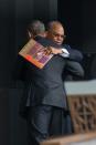 US President Barack Obama hugs Founding Director of the National Museum of African American History and Culture, Lonnie Bunch, at its opening ceremony on September 24, 2016 in Washington