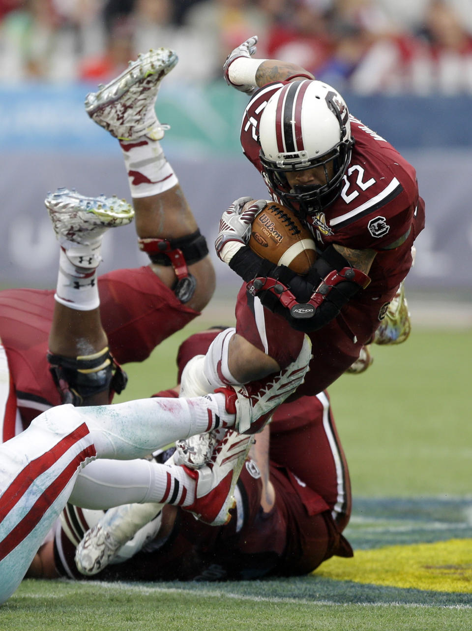 South Carolina running back Brandon Wilds (22) dives for a short gain as he is tripped up by the Wisconsin defense during the first half of the Capital One Bowl NCAA college football game in Orlando, Fla., Wednesday, Jan. 1, 2014.(AP Photo/John Raoux)