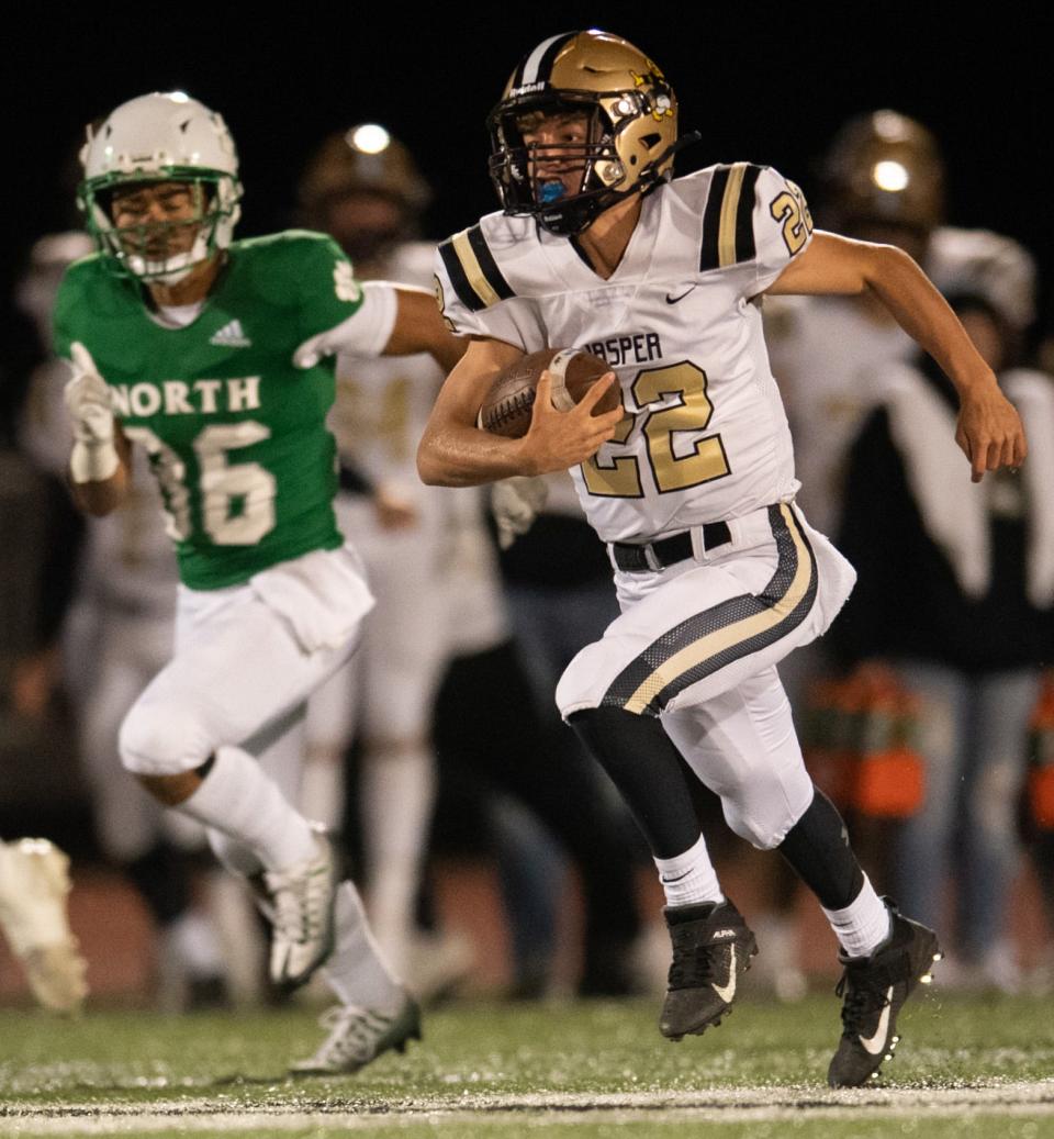 Jasper’s Max Bueltel (22) runs the ball as the Jasper Wildcats play the North Huskies at Bundrant Stadium in Evansville, Ind., Friday evening, Oct. 7, 2022. 