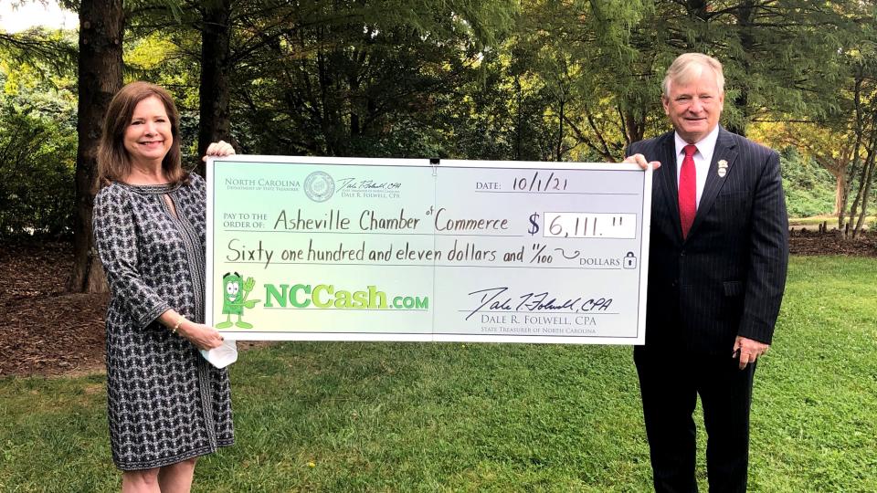 North Carolina State Treasurer Dale Folwell presents a check from the unclaimed property fund to the Asheville Chamber of Commerce in this file photo.
