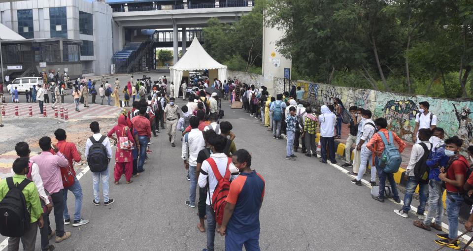 People line up for Covid-19 rapid antigen tests, at a testing facility for travellers at Anand Vihar Bus Terminal, on August 16, 2020 in New Delhi, India. (Photo by Sonu Mehta/Hindustan Times via Getty Images)